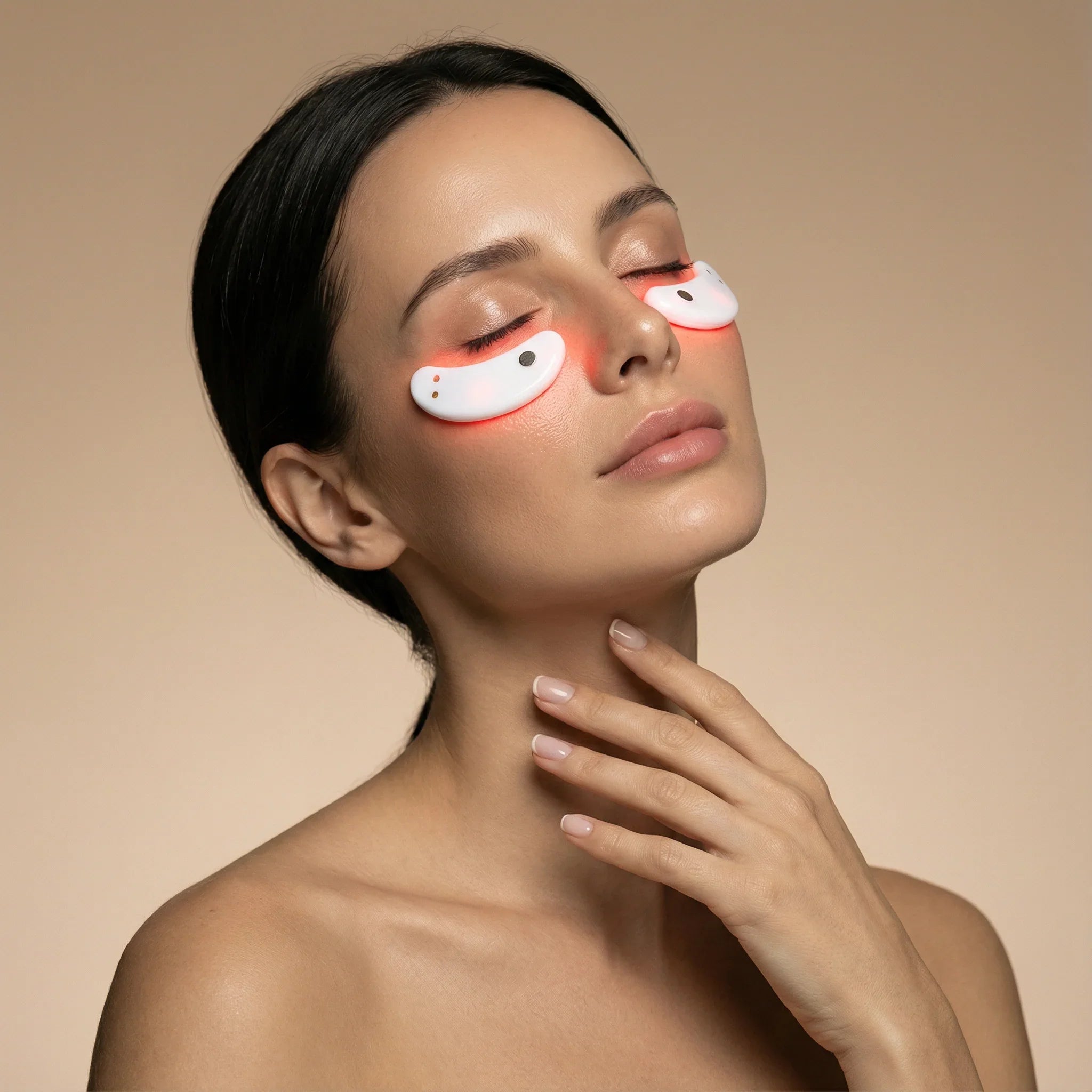 Woman wearing NEO LUMINUS Red Light Therapy Eye Pods under her eyes